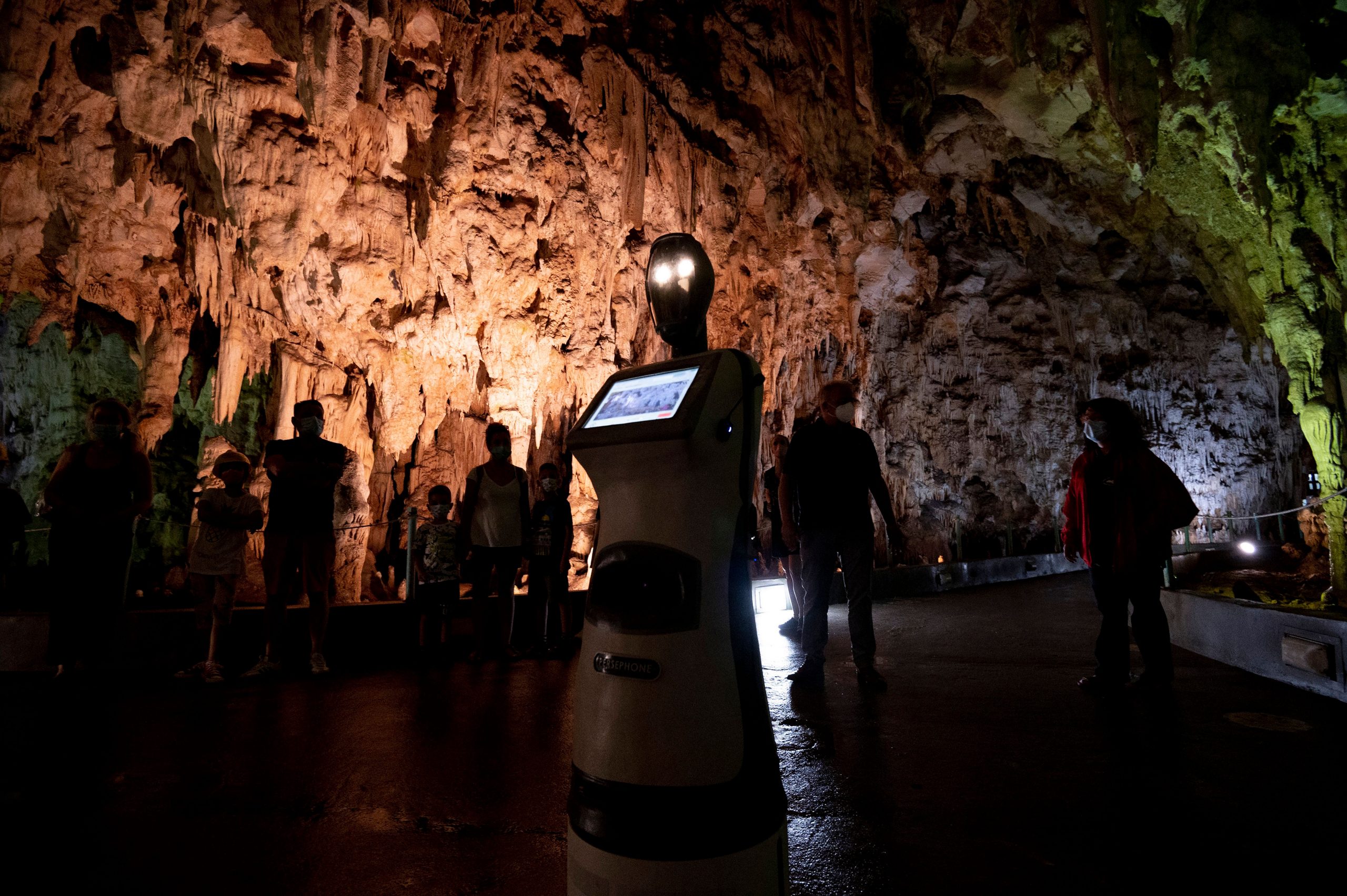 Persephone, the robot guide, leads visitors in a Greek cave