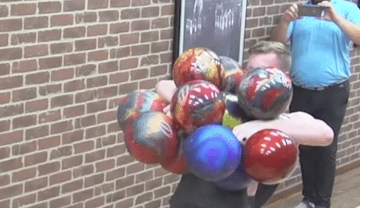 US man holds 16 bowling balls at the same time to make world record. Watch