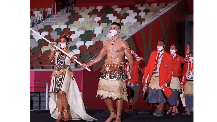 Tongas Olympic shirtless flag-bearer is back in all his glistening glory