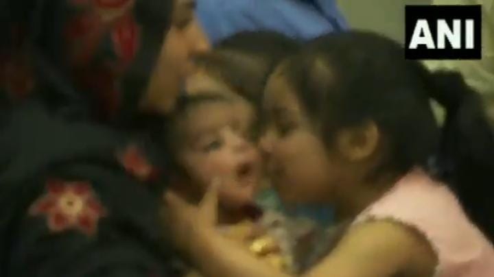 Baby evacuated from Afghanistan plays on her mother’s lap. Watch