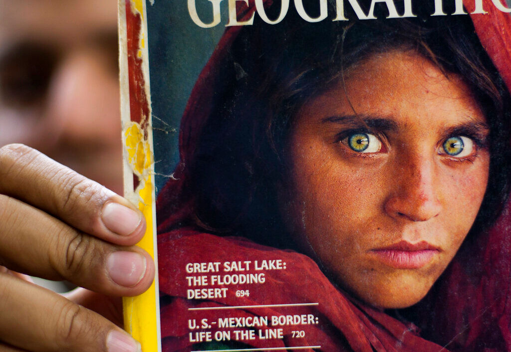 Famed green-eyed Afghan girl from cover portrait is evacuated to Italy
