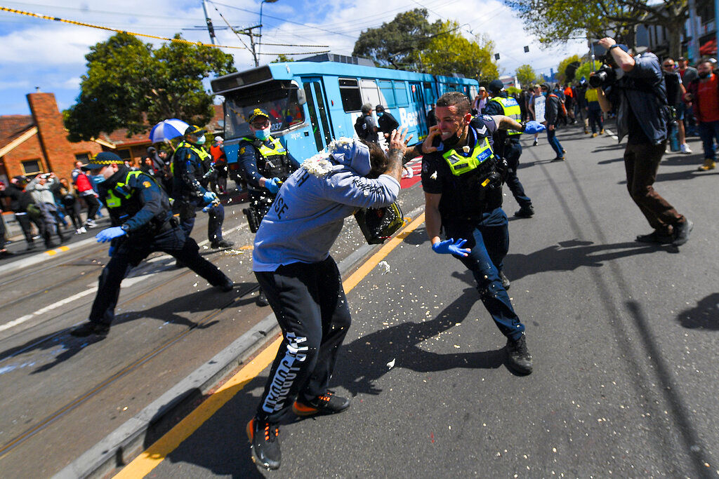 Hundreds charged as anti-lockdown protesters clash with police in Australia