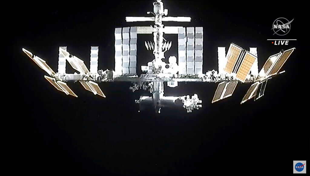 Space junk sends seven station astronauts to docked capsules