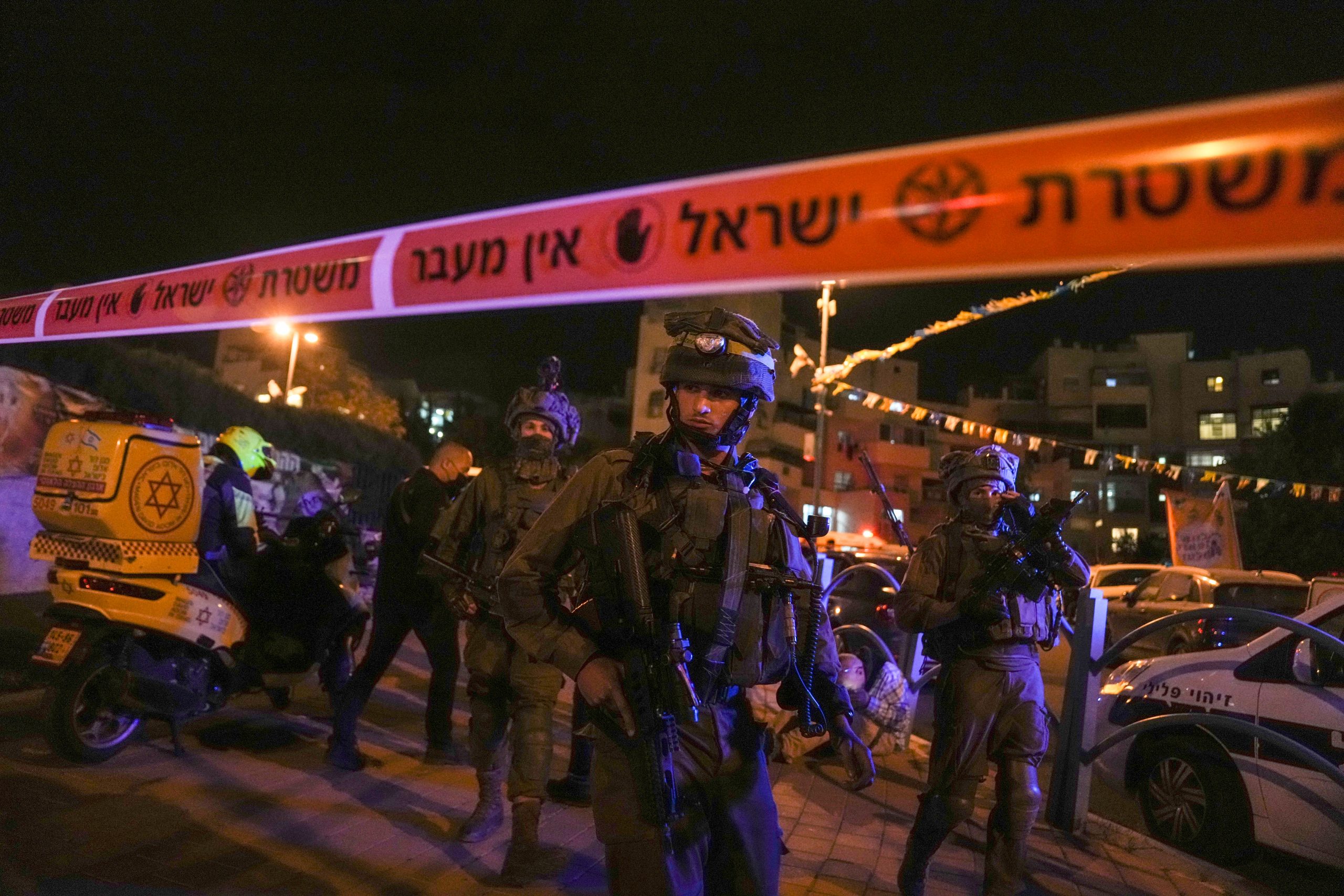 Israeli security forces search for attackers who killed three in mass stabbing