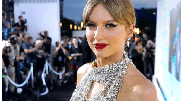 Watch: Taylor Swift beams in silver-chain dress at VMAs 2022