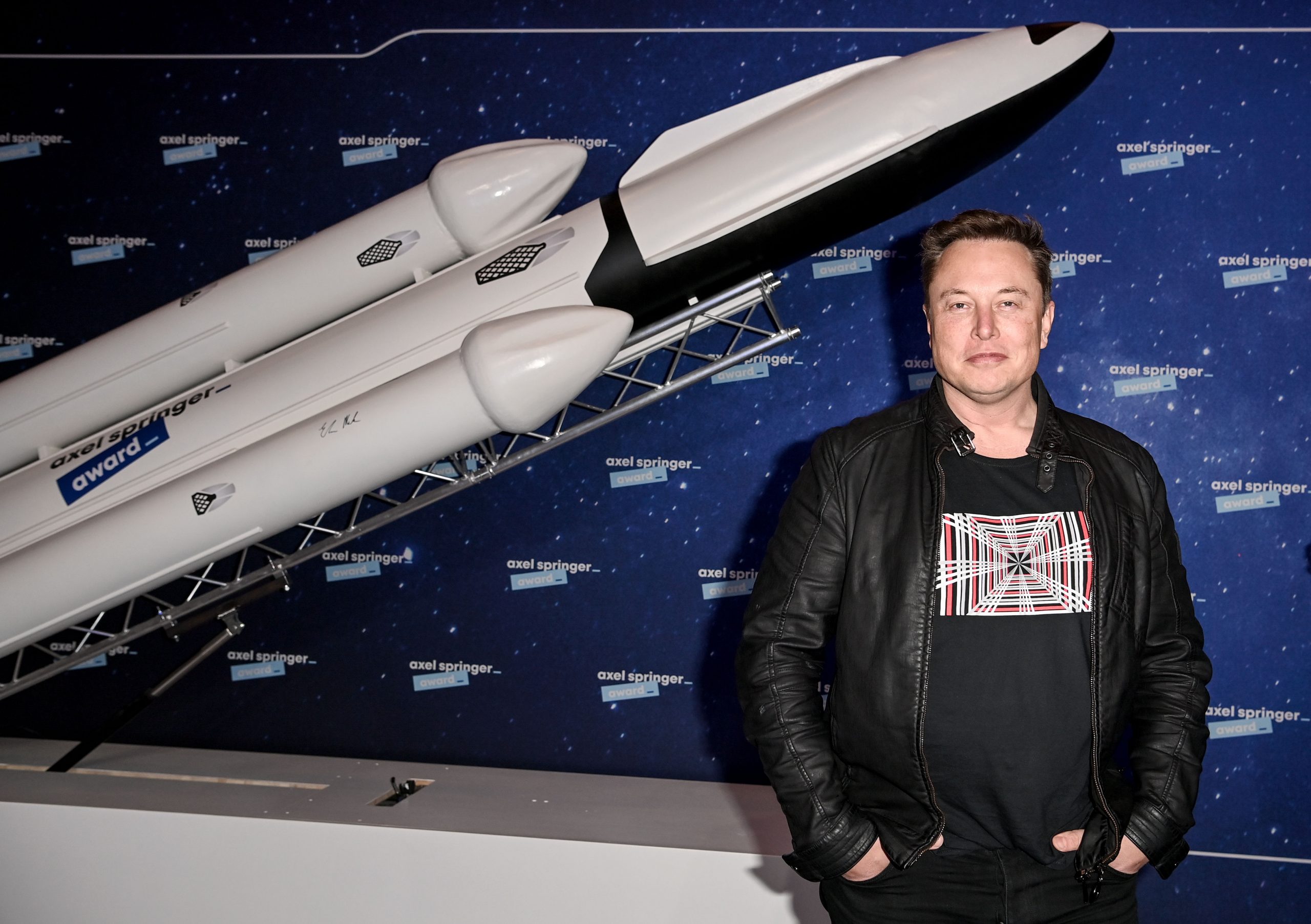 Tesla boss Elon Musk reacts to a joke on Amazon founder Jeff Bezos