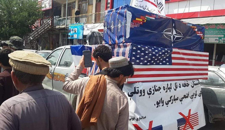 Taliban allies celebrate US exit with American, NATO flags draped on coffins