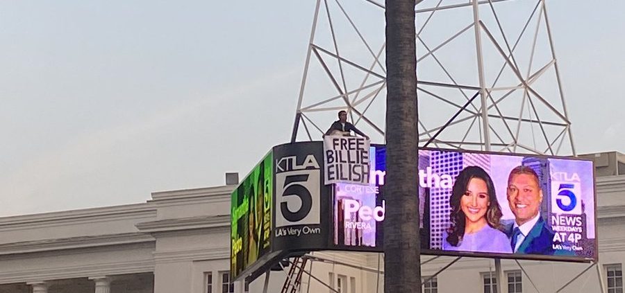 Man climbs 162-foot KTLA tower in California with guitar, holding ‘Free Billie Eilish’ sign