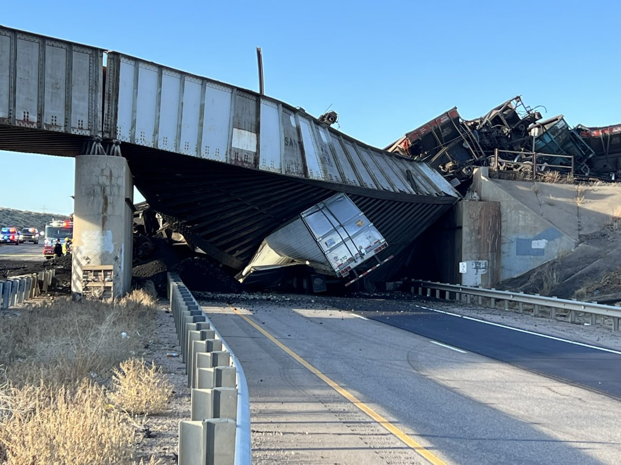 Cargo train derails near Pueblo, Colorado, crushing vehicle on I-25; Casualties uncertain: Watch Video