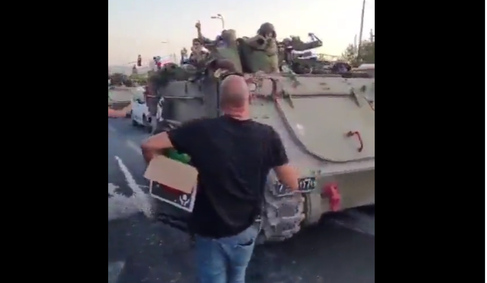 Israel’s military tanks enter Gaza to cheering citizens throwing water bottles, food packs | Video